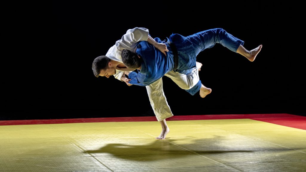 Judoka throwing his partner to the ground